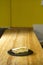 Vertical closeup shot of quesadilla on a black round board on a wooden table