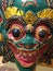 Vertical closeup shot of a scary colorful tribal mask with its teeth out and bulging eyes