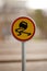 Vertical closeup shot of a slippery road sign with a blurred background