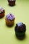 Vertical closeup shot of small cupcakes with colorful creams