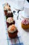 Vertical closeup shot of small cupcakes in a row on a folded kitchen towel