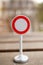 Vertical closeup shot of a small stop traffic sign figure with a blurred background