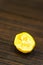 Vertical closeup shot of a squeezed fresh lemon on a wooden surface