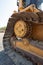 Vertical closeup shot of a track of a bulldozer