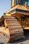 Vertical closeup shot of a track of a bulldozer