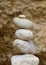 Vertical closeup shot of white pebbles balanced on top of each other