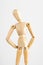 Vertical closeup shot of a wooden pose doll with its hands on its hips