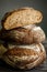 Vertical closeup three pieces of handmade round brown rye bread