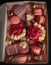 Vertical closeup of a Valentine treat box surprise with cupcakes, cakesicles, and chocolate candies
