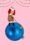 Vertical collage image of mini santa claus grandfather mopping big bauble ball toy isolated on creative pink background