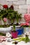 Vertical composition of hyacinth flowers, decorative pots, garden tools on an old brick background. Home gardening