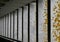 Vertical concrete pillars with yellow lichen moss growth and grey ceiling above