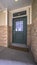 Vertical Covered cement patio with wooden front door