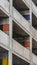 Vertical Covered parking lot of a concrete building viewed from outside on a cloudy day