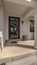 Vertical Covered porch and glass entrance door to a house