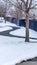 Vertical crop Curvy narrow road on snow covered ground in winter with houses background