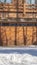 Vertical crop Facade of a luxury wooden home in Park City Utah with snowy driveway in winter