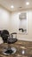 Vertical crop Hairdresser chair and backwash shampoo bowl inside salon with bench and mirror