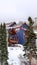 Vertical crop Houses on snowed in hill terrain with evergreens in Park City Utah in winter