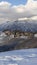 Vertical crop Pristine landscape of Wasatch Mountains with houses on its snow covered terrain