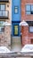 Vertical crop Residential building facade with colorful wall and balconies with glass railing