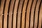 Vertical curved light colored wooden slat background.