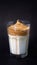 Vertical dalgona coffee glass, whipped cold coffee with milk