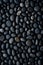 vertical dark pebbles texture background, closeup black smooth stones
