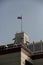 Vertical day shot of three cctv surveillance cameras on the walls of the Parlament, a tower of the white house and the flag of