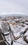 Vertical drone shot of a city view covered in snow