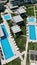 Vertical drone shot of pools and resorts on the seaside