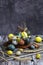 Vertical Easter composition. Painted chicken and quail eggs in a basket on a rustic background