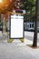 Vertical empty billboard placeholder template on the city bus stop, information banner template, space for mockup layout.