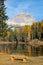 VERTICAL: Empty wooden bench faces the breathtaking Lago d\\\'Antorno and Dolomites