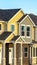 Vertical Exterior view of townhomes with gable roof stairs and square columns at entrance