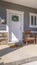 Vertical Facacde of a home with furniture on the welcoming sunlit porch