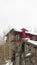 Vertical Facade of homes ith horizontal siding on exterior wall and fresh snow on roofs