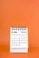 Vertical of Feburary 2024 table calendar on orange background