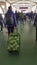 VERTICAL Female traveler carries her travel bags while walking to train platform