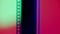 Vertical film strip on a pink and white gradient background, close up. 35mm film slide frame. Long, retro film strip