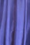 Vertical folds on blue organza curtains