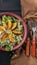 Vertical food banner. Close-up vegan salad with romano leaves and fried peach. Top view