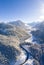 vertical format winter picture with road to the village of heiterwang in tyrol with wooded mountains