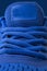 Vertical fragment of blue sneaker close up