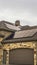 Vertical frame Beautiful facade of a home with stone wall front porch and arched garage doors