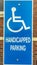 Vertical frame Close up of Handicapped Parking sign against blurred red brick wall of church