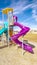 Vertical frame Colorful blue and purple slides in kids playground