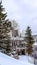 Vertical frame Evergreens and houses on snowy hill in Park City Utah viewed in winter