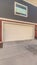 Vertical frame Exterior of three storey townhomes with garages and red gray and beige walls