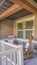 Vertical frame Facade of a home with rocking chairs on the porch and wreath on the front door